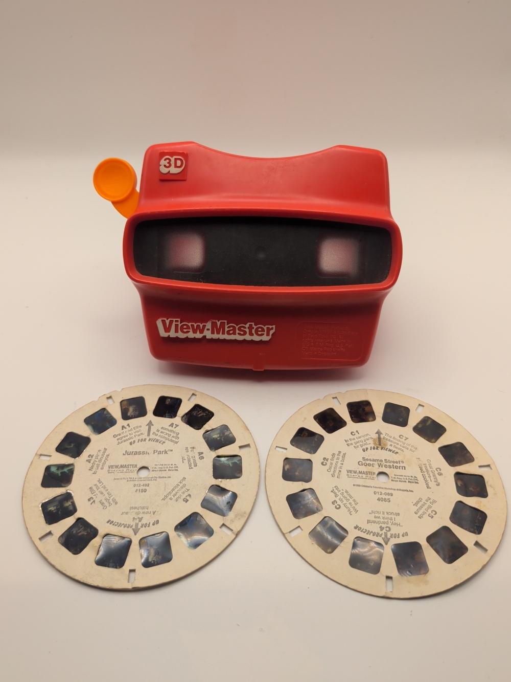 Vintage Red View-Master 3D Viewer with Jurassic Park and Sesame Street West. (H)